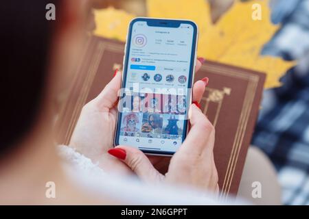 KIEV, UKRAINE. FEBRUARY 10, 2023 : The main logo popular apps Instagram, Facebook on your smartphone screen in female hands. High quality photo Stock Photo
