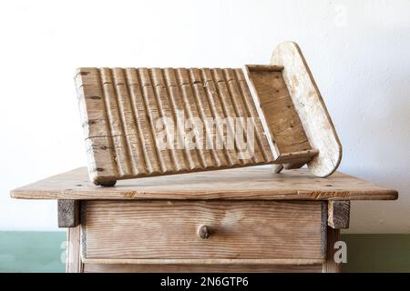 Old wooden washboard. Displayed over wooden table Stock Photo