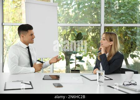 Office employees talking at table during meeting Stock Photo