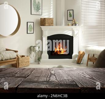 Empty wooden surface and blurred view of fireplace in room Stock Photo