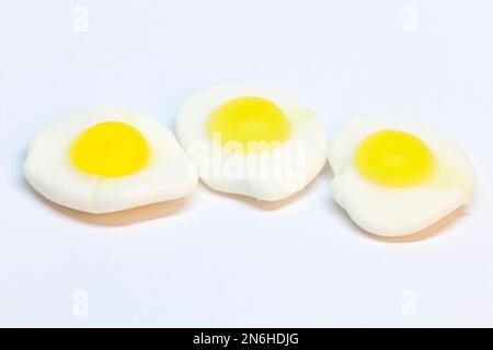 three pieces of fried candy eggs on a white background Stock Photo