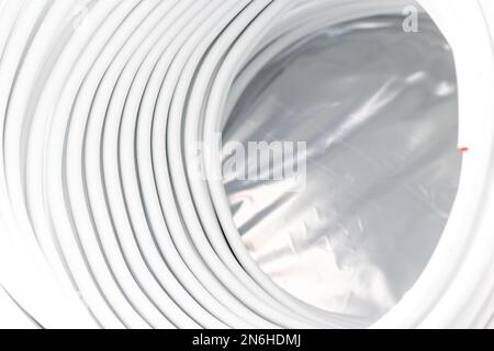 Coiled water pipes for underfloor heating ready for installing, concept of heated floor Stock Photo