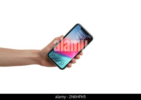 MYKOLAIV, UKRAINE - JUNE 9, 2020: Woman holding  iPhone X with locked screen on white background, closeup Stock Photo