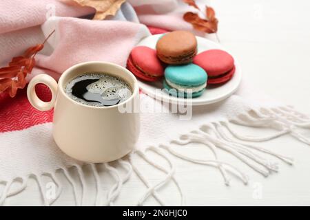Composition with hot drink and warm plaid on white wooden table Stock Photo