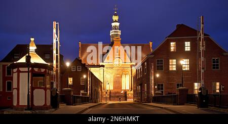 Illuminated New Church behind new bascule bridge at the Red Siel in the evening, Emden, East Frisia, Lower Saxony, Germany Stock Photo