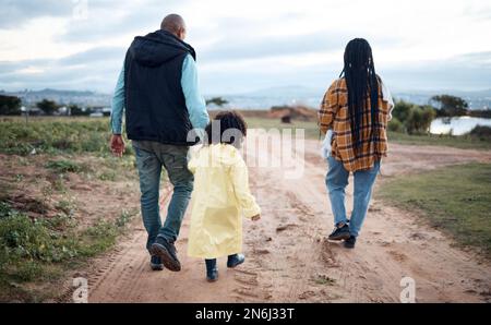 Agriculture, farm and walking family with girl for quality time, adventure and bonding in countryside. Sustainability, farming and back of mom, dad Stock Photo