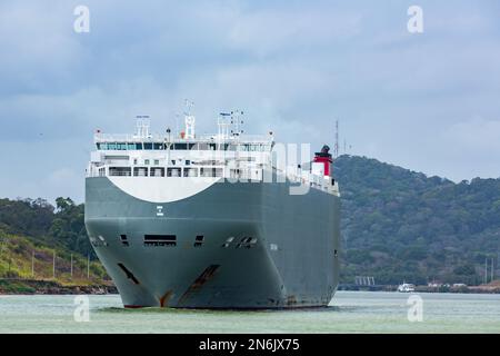 The Genius Highway, a large car carrier, moves through the Culebra Cut in the Panama Canal.  Gamboa, Panama. Stock Photo