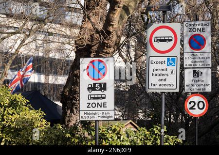 Multiple traffic road signs warning of weight limit, speed limit, controlled zone times, on 9th February 2023, in London, England. Stock Photo
