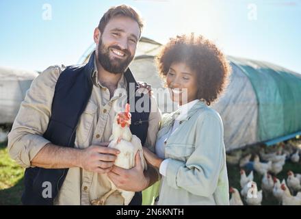 Couple, farmer and agriculture, chicken and livestock, poultry farming and nature, organic free range agro business. Interracial people, team and Stock Photo