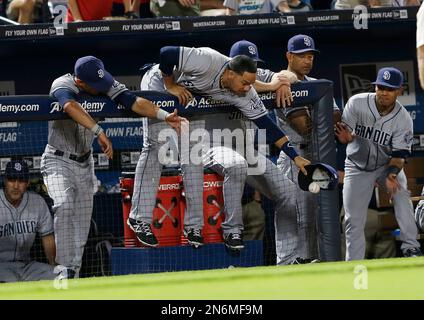 From left, Atlanta Braves catcher Tyler Flowers, left, shortstop Dansby  Swanson and relief pitcher Sean Newcomb gather on the mound after Newcomb  hit New York Mets' Robinson Cano with a pitch during