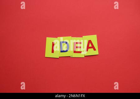 Idea concept. The inscription on the yellow tags on a red background. Stock Photo