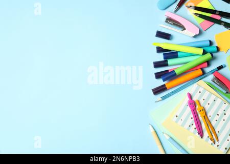 Different stationery on light blue background, flat lay with space for text. Back to school Stock Photo