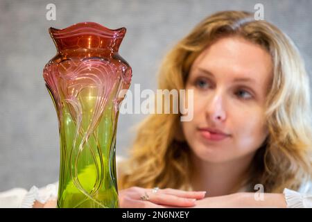 London, UK.  10 February 2023. A technician presents a rare Art Nouveau cut glass vase, circa 1900, Henri Van der Velde: made by Val Saint Lambert (Est. £2,000 - £3,000) at a photocall for the sale ‘Unity in Variety: The David Bonsall Collection of Decorative Arts and Design’ at Bonhams New Bond Street.  360 lots featuring 20th century decorative arts will be offered for sale on 14 February.  Credit: Stephen Chung / Alamy Live News Stock Photo