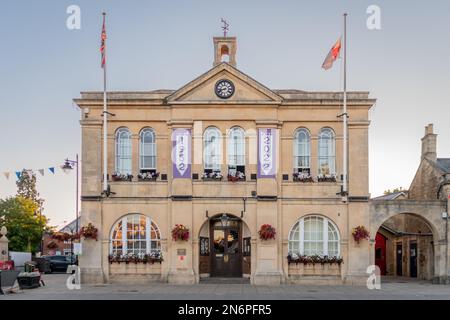 The town hall in Melksham Wiltshire seen front on with 2 flags on poles and vertical banners marking the platinum jubilee of Queen Elizabeth II Stock Photo