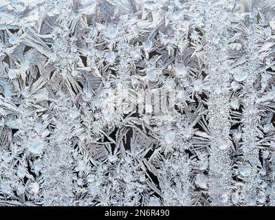 texture of frost pattern on window glass closeup on cold winter day Stock Photo