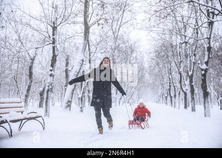 Father with his child spending time outside on winter day. Christmas vacation Stock Photo