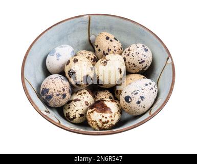 many boiled quail eggs in ceramic bowl cutout on white background Stock Photo