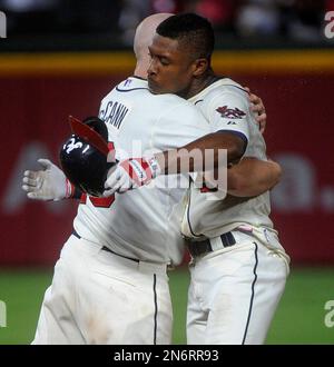 Atlanta Braves' B.J. Upton, right, celebrates with Freddie Freeman after  scoring on a single hit by Andrelton Simmons during the third inning of a  baseball game against the Chicago Cubs in Chicago