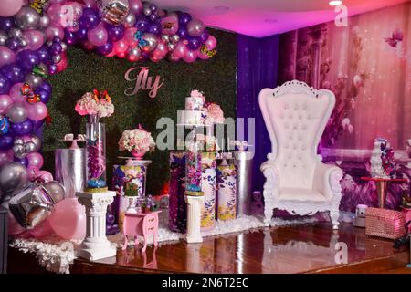 wedding reception. Birthday Cake on a background balloons party decor. Copy space. Celebration concept. Trendy Cake. Candy bar. Table and  Queen chair Stock Photo