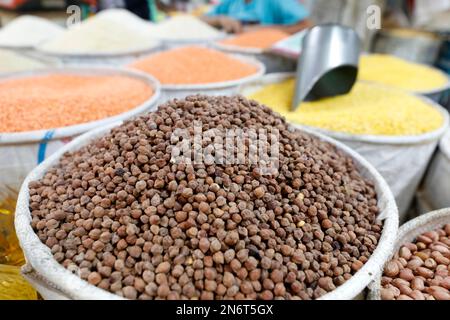 Dhaka, Bangladesh - February 10, 2023: Bangladeshi grocery vendors wait for customer at Karwan Bazar kitchen market in Dhaka, Bangladesh. Stock Photo