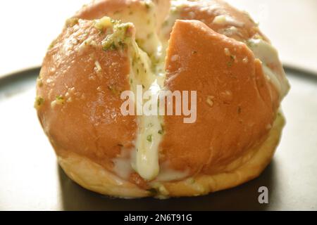 bread bun stuffed garlic cheese sauce arranging on plate Stock Photo