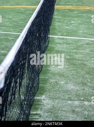 net on paddle court with green artificial grass and sand vertically with copy space Stock Photo