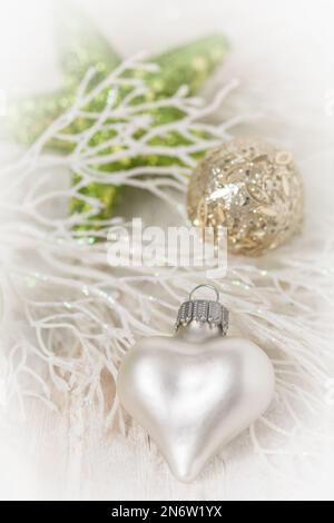 Christmas decoration with white heart and light green colors, soft focus, vertical Stock Photo