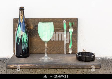 Cutlery arrange, stained with green, as outdoor decoration of a tapas bar in the village of Ajuy, Fuerteventura. Stock Photo
