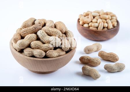 Bowl full of shelled and roasted peeled peanuts on white background, closeup Stock Photo