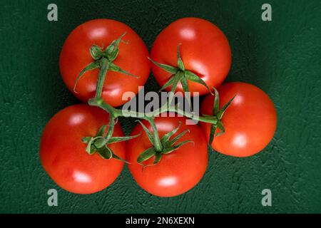 A group of grape tomatoes on a green background,top view Stock Photo