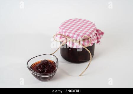 Homemade strawberry jam, jar and small bowl with jam isolated on white background. Stock Photo