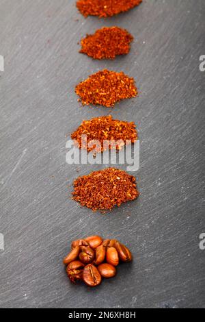 Piles of ground coffee beans from coarsely ground to fine Stock Photo