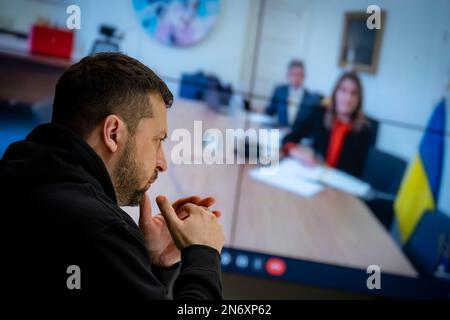 Kyiv, Ukraine. 10th Feb, 2023. Ukrainian President Volodymyr Zelenskyy, left, delivers remarks during an online summit by video link with the International Olympic Committee from the Mariyinsky Palace, February 10, 2022 in Kyiv, Ukraine. Zelenskyy has called for a total ban of all Russian athletes from the 2024 Summer Olympic Games. Credit: Ukraine Presidency/Ukrainian Presidential Press Office/Alamy Live News Stock Photo