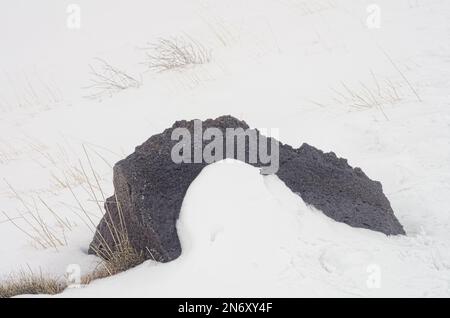 contrast grey volcano rock and white snow in Etna National Park, Sicily, Italy Stock Photo
