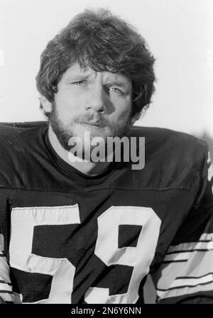 Steelers linebacker Jack Ham watches as a trainer untapes his