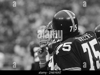 Steelers linebacker Jack Ham watches as a trainer untapes his shoes in  Pittsburgh on Sunday, Dec. 23, 1974 after 32-14 win over the Buffalo Bills.  Ham recovered a second quarter fumble, the