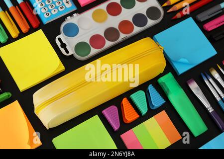 Different stationery on blackboard, closeup. Back to school Stock Photo
