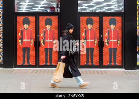 London, UK.  10 February 2023.  A woman passes a souvenir shop in Oxford Street.  The Office for National Statistics (ONS) has reported a 0.5% fall in economic output during December, partly due to strike action, with the UK narrowly avoiding falling into recession in 2022 after the economy saw zero growth between October and December.  Jeremy Hunt, Chancellor of the Exchequer, said the figures showed 'underlying resilience' but said 'we are not out of the woods' However, The Bank of England still expects the UK to enter recession in 2023.  Credit: Stephen Chung / Alamy Live News Stock Photo