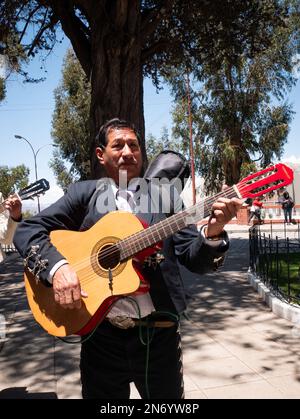 La Paz, Bolivia - October 1 2022: Bolivian Man Playing the Guitar in a Square on a Sunny Day Stock Photo