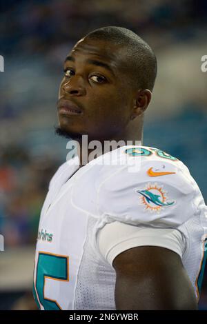 Dion Jordan, defensive end from Oregon, holds up a Dolphins Jersey