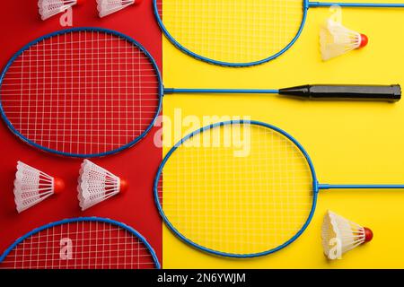 Badminton rackets and shuttlecocks on color background, flat lay Stock Photo