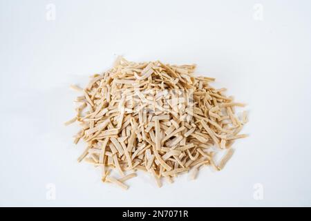 Top view of uncooked traditional Turkish Ottoman food, dry homemade egg noodles isolated on white background. Stock Photo