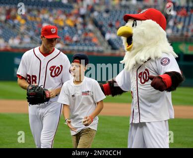 Washington Nationals starting pitcher Taylor Jordan walks off with Chris  Garcia and team mascot Screech, after Garcia threw out a ceremonial first  pitch before a baseball game between the Washington Nationals and