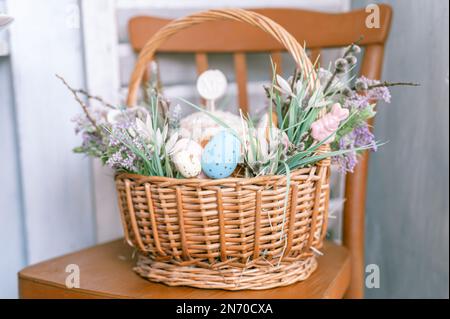 Russia, Moscow, 04.09.2022. happy easter holiday time in spring season. basket with painted eggs, easter baked cakes, flowers and plants, and sweet ra Stock Photo