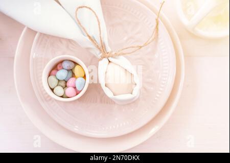 happy easter holiday in springtime. festive home decor. traditional food. white beige chicken egg wrapped in pale blue cloth like rabbit or bunny ears Stock Photo