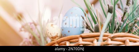 happy easter holiday time in spring season. basket with painted eggs, easter baked cakes, flowers and plants, and sweet rabbits. festive home decor. t Stock Photo