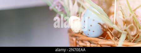 happy easter holiday time in spring season. basket with painted eggs, easter baked cakes and sweet rabbits. festive home decor. traditional food. mock Stock Photo