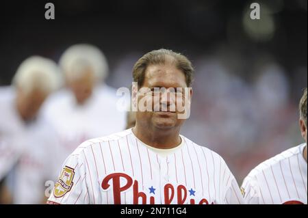 Philadelphia Phillies catcher Darren Daulton, right, watches Atlanta Braves  first baseman Fred McGriff get congratulated by teammate Otis Nixon after  McGriff hit a two-run home run in the first inning of Game