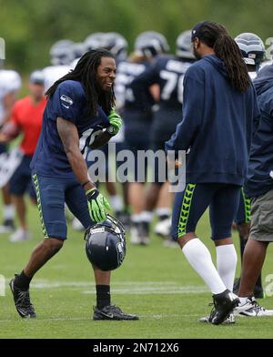 Seattle Seahawks cornerback Richard Sherman, left, begins to take off the  jersey that belongs to injured wide receiver Sidney Rice, right, after  Sherman wore it as a joke during NFL football training camp Friday, Aug. 2,  2013, in Renton, Wash. (AP Phot