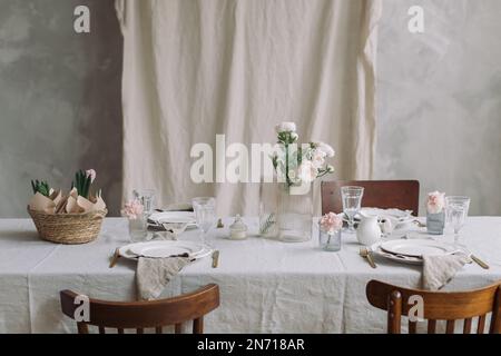 Table setting with pink hyacinths and spring flowers Stock Photo